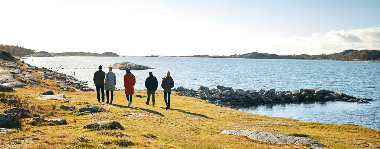 people walking along the sea